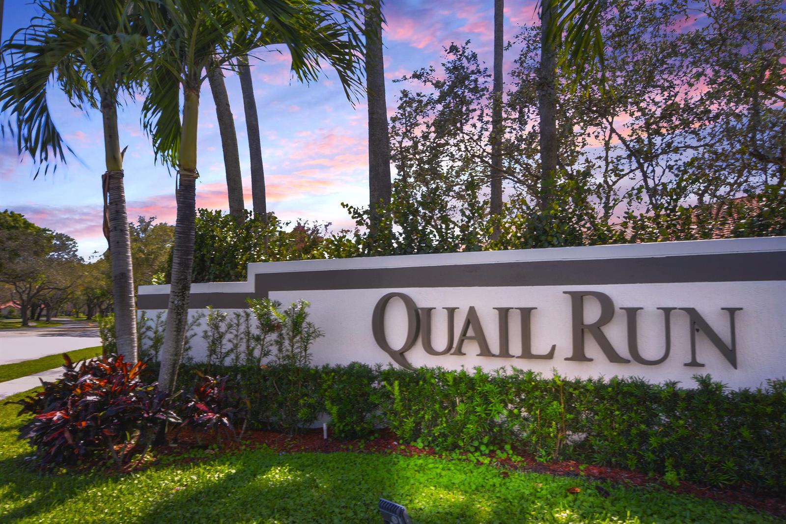 A white monument sign with the words Quail Run stands in front of palm trees — 2406 Aspen Way # 2406, Boynton Beach FL 33436, BOYNTON BEACH, FL