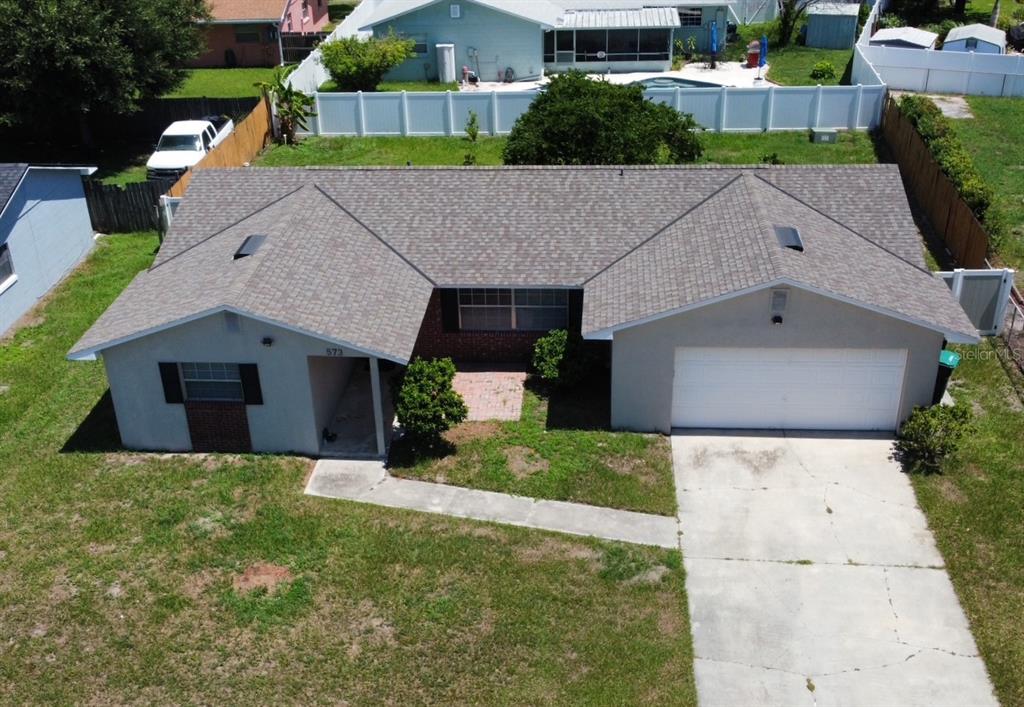 An aerial view of a single-story house with a shingled roof and attached garage — 573 BENJAMIN FRANKLIN PLACE, ORLANDO, FL