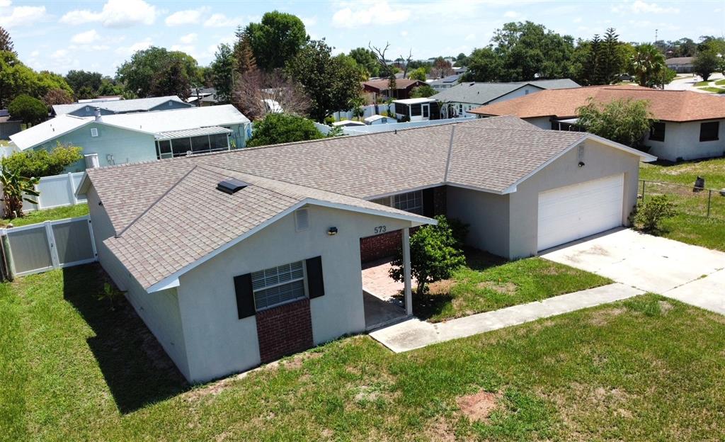 An aerial view of a single-story house with a gray exterior, shingled roof, and garage — 573 BENJAMIN FRANKLIN PLACE, ORLANDO, FL