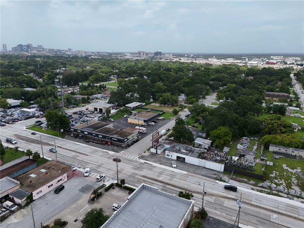 An aerial view shows a commercial area with buildings, parking lots, and a multi-lane road — 1221 25TH STREET, ORLANDO, FL