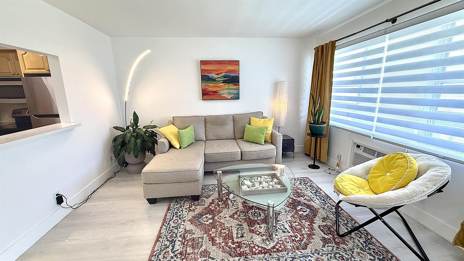 A living room features a sectional sofa, a glass coffee table, and a patterned rug — 78 Harwood H Crescent, Deerfield Beach FL 33442, DEERFIELD BEACH, FL