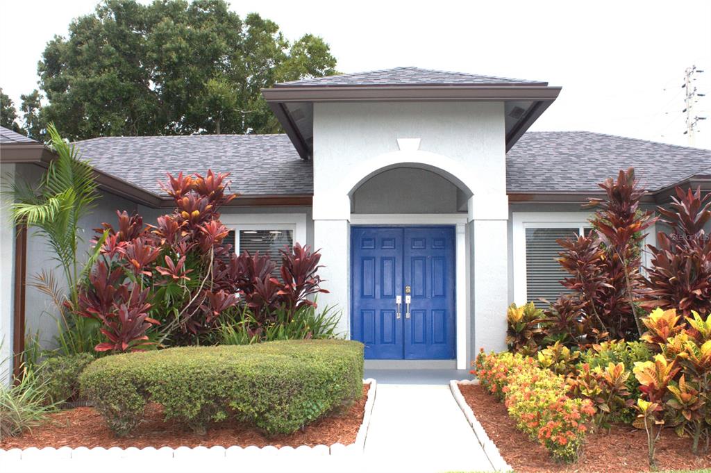 The exterior of a house features a blue double front door under a covered entryway — 12480 SW 2ND STREET, PLANTATION, FL