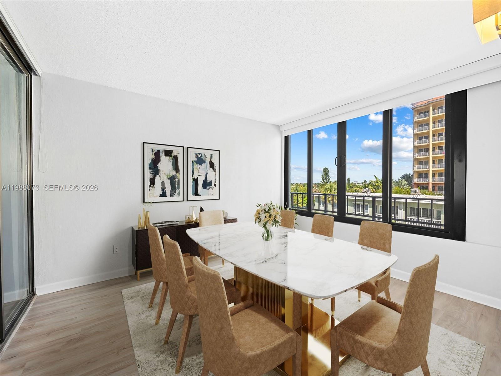 A dining room features a marble table, tan chairs, and large windows with exterior views — 1401 S Ocean Blvd # 407, Pompano Beach FL 33062, POMPANO BEACH, FL