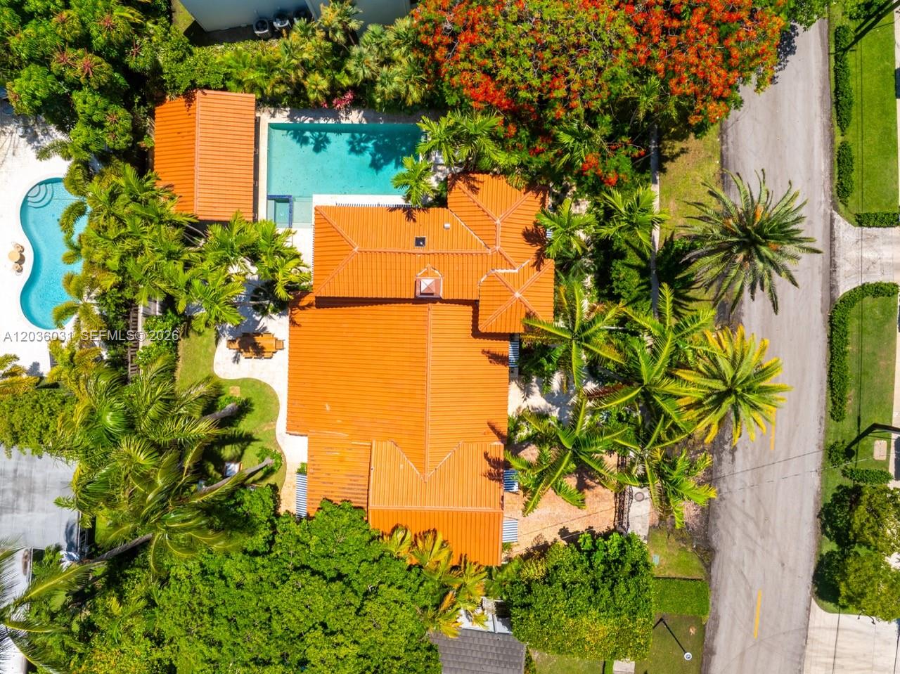 An aerial view shows a house with a terracotta roof, a swimming pool, and palm trees — 4727 N Bay Rd, Miami Beach FL 33140, MIAMI BEACH, FL