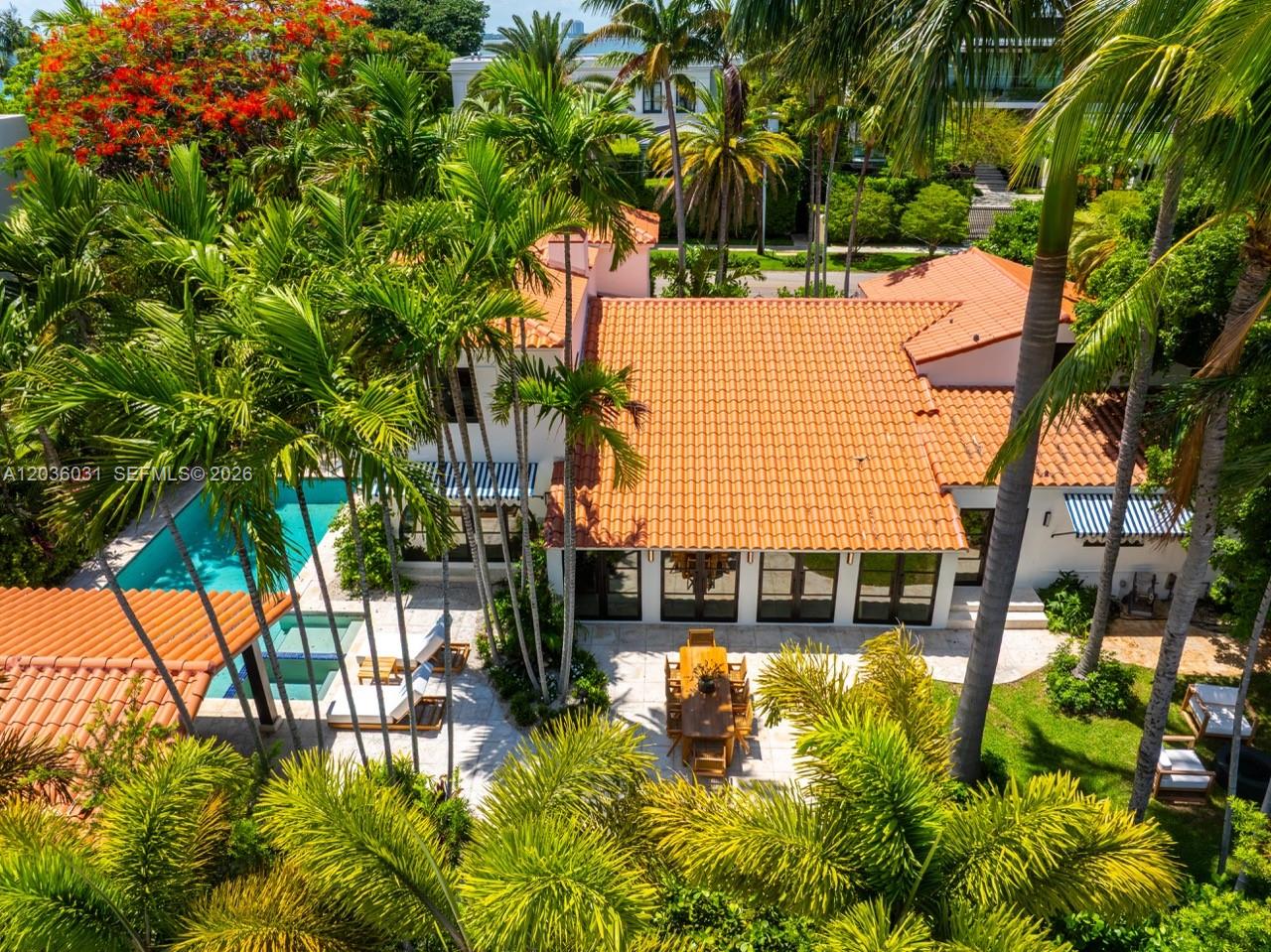 An aerial view of a house with a terracotta roof, swimming pool, and patio area — 4727 N Bay Rd, Miami Beach FL 33140, MIAMI BEACH, FL