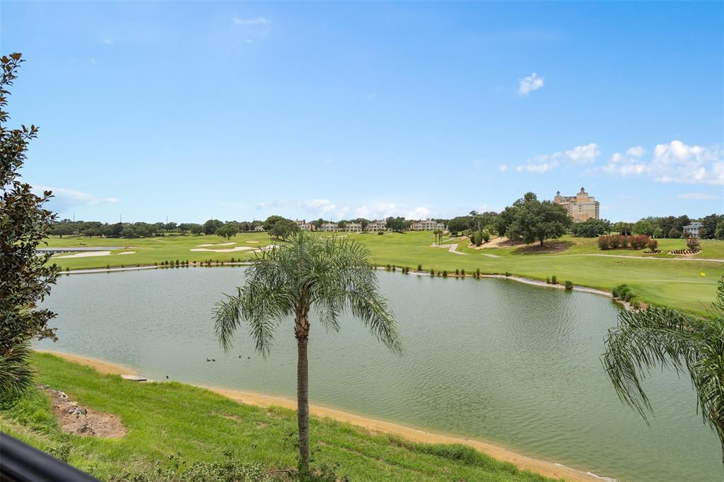 A view of a golf course and a pond from an elevated outdoor balcony — 1402 TITIAN COURT, REUNION, FL