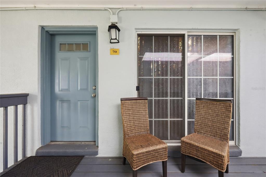 A light blue door and sliding glass door are on a porch with two chairs — 4888 CONWAY ROAD UNIT 70, ORLANDO, FL
