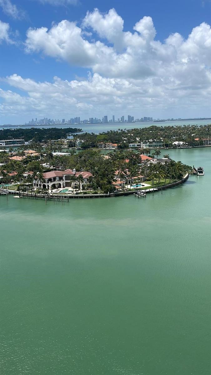 An aerial view of a waterfront residential island with luxury homes and palm trees — 6900 Bay Dr # 7A, Miami Beach FL 33141, MIAMI BEACH, FL