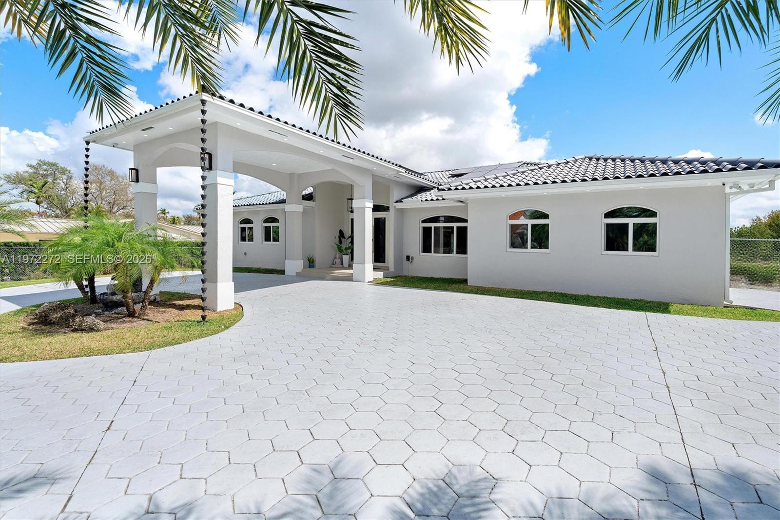 A single-story house with a white stucco exterior, tile roof, and a large porte-cochère — 135 SW 125th Ave, Miami FL 33184, MIAMI, FL