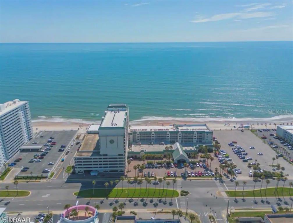 An aerial view shows a beachfront hotel complex with a parking lot and ocean — 2700 N ATLANTIC AVENUE UNIT 415, DAYTONA BEACH, FL
