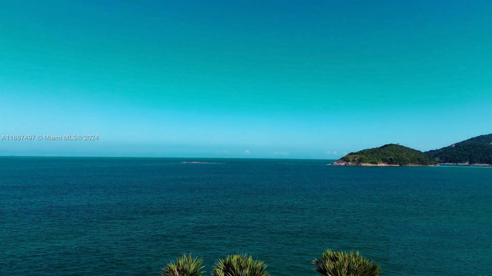 A view of the ocean with a small island in the distance — 198 Passeio ave, SP 11444-380, SP