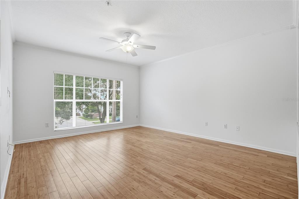 A home office features built-in wooden bookshelves, a modern desk, and a large window with blinds — 809 S OREGON AVENUE UNIT B, TAMPA, FL