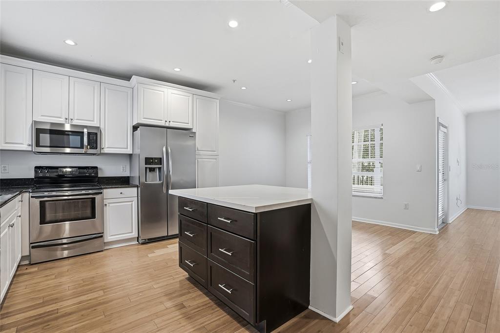 A dining area features a round marble table, four modern chairs, and wall art — 809 S OREGON AVENUE UNIT B, TAMPA, FL