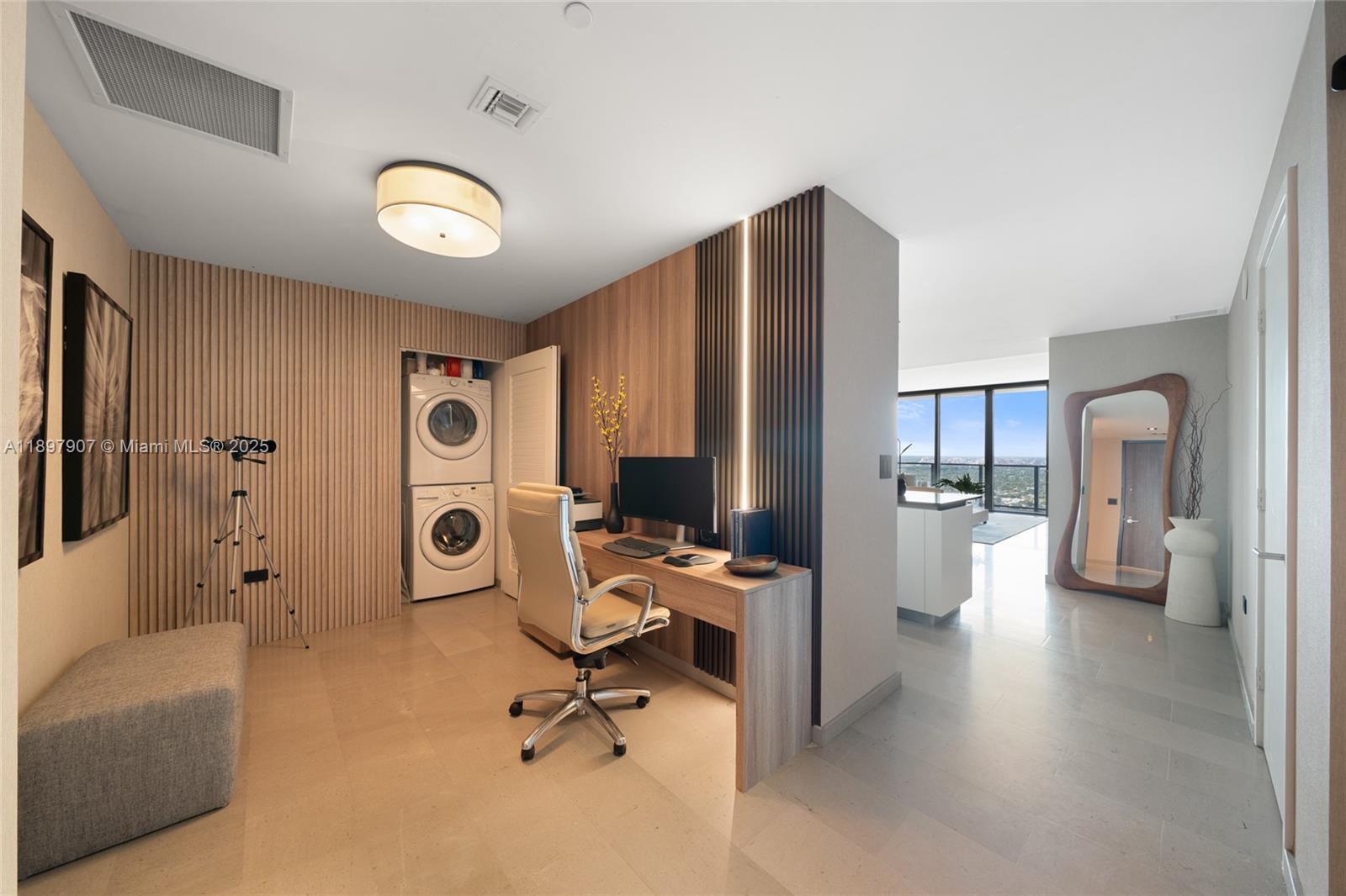 A home office area features a built-in desk, wood-slat walls, and a stacked laundry unit — 88 SW 7th St # 3910, Miami FL 33130, MIAMI, FL