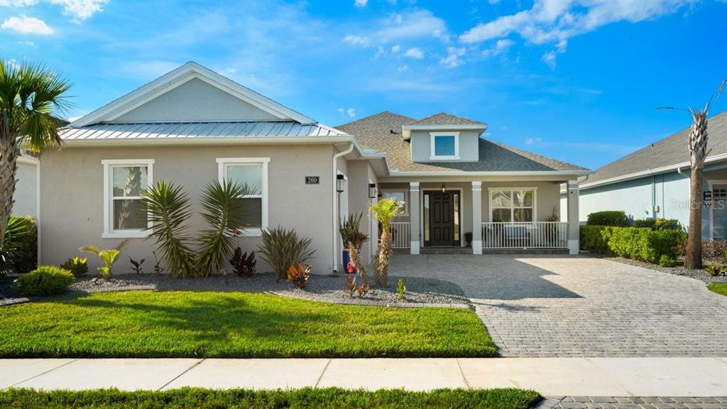 A single-story house with a gray exterior, a paved driveway, and a front porch — 260 FUCHSIA STREET, DAYTONA BEACH, FL