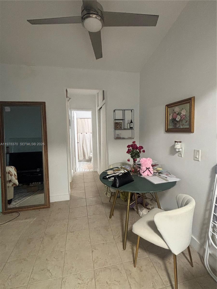 A dining area features a round table, a white chair, and a full-length floor mirror — 75 Washington Ave # 12A, Miami Beach FL 33139, MIAMI BEACH, FL