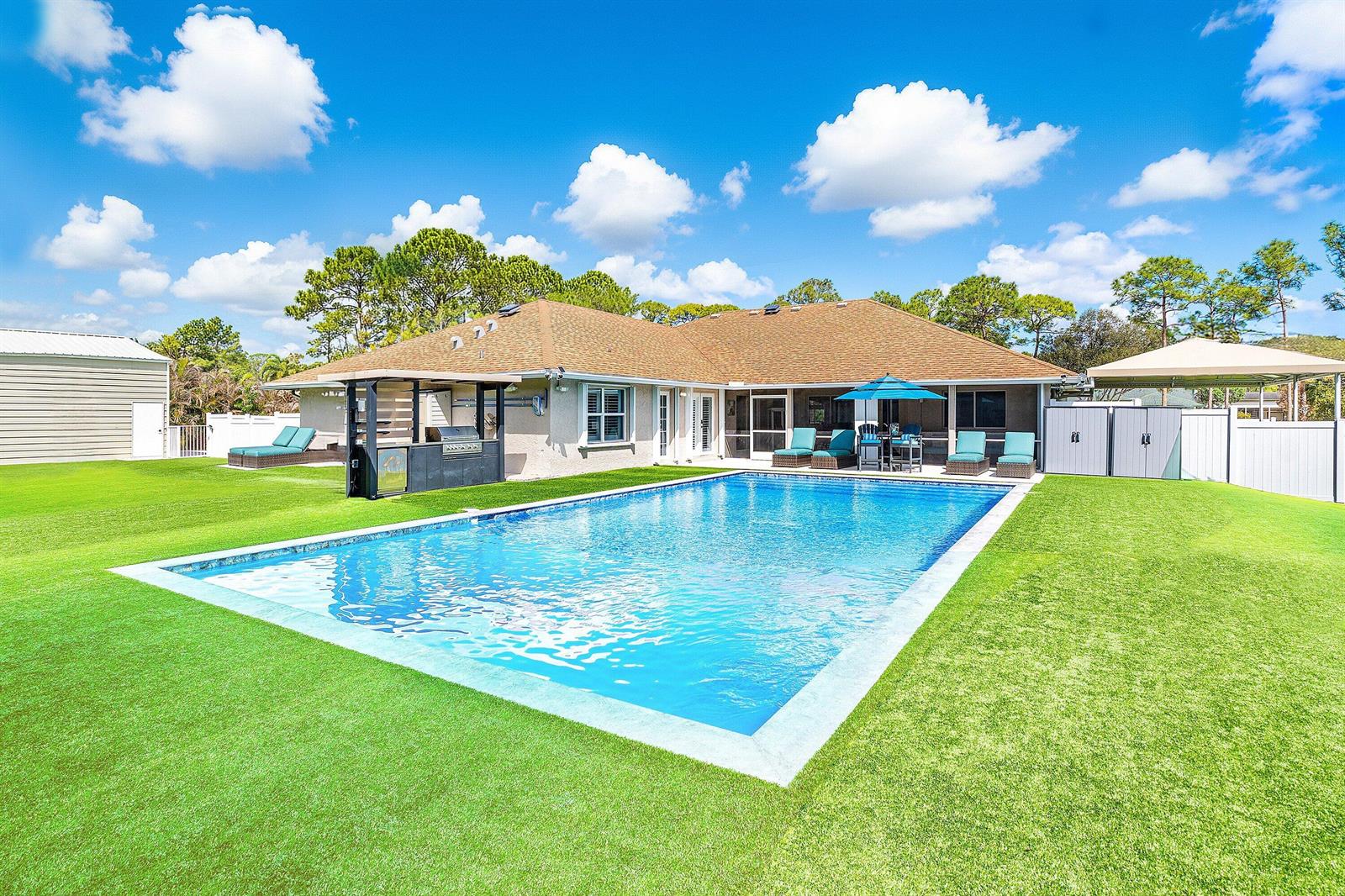 An aerial view of a single-story house with a brown roof and a large lawn — 15436 66th Court N, Loxahatchee FL 33470, LOXAHATCHEE, FL