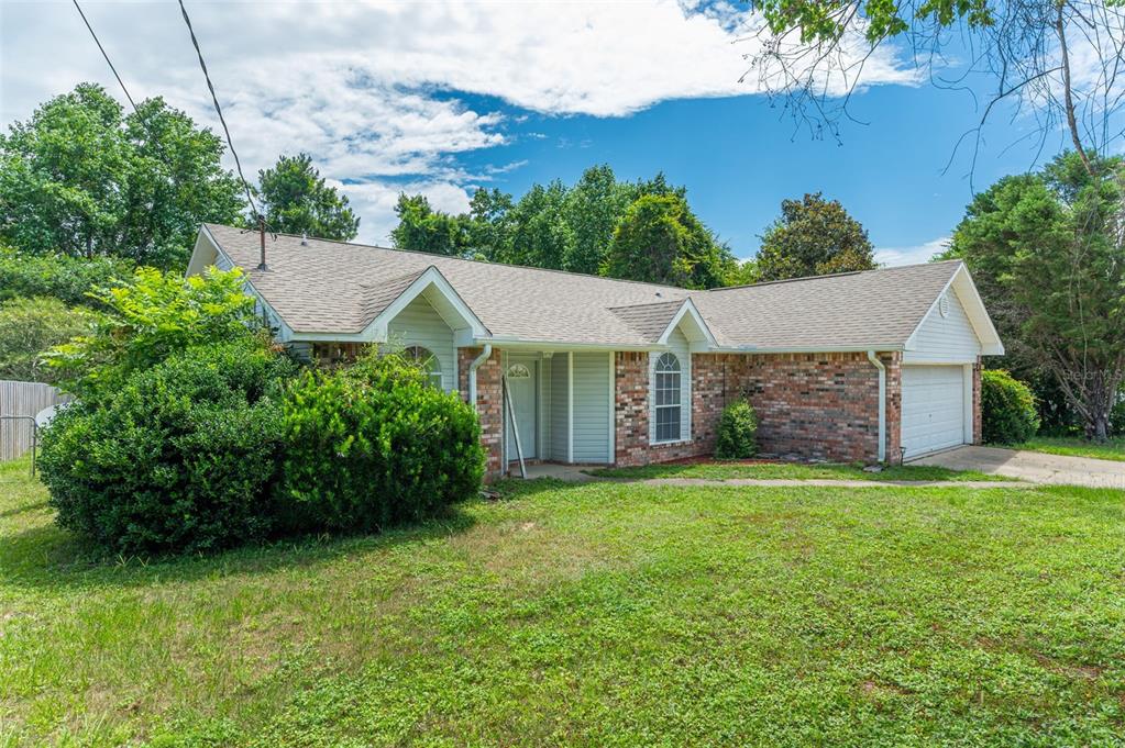 A single-story house with a brick and siding exterior, a shingled roof, and a garage — 1206 EGO DRIVE, CRESTVIEW, FL