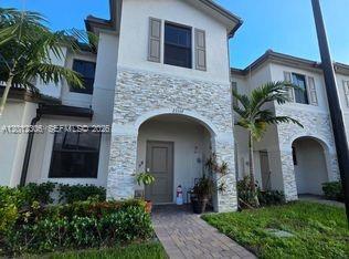 A two-story residential building with a stone-veneer facade and a covered entryway — 12912 SW 233rd Ter, Homestead FL 33032, HOMESTEAD, FL