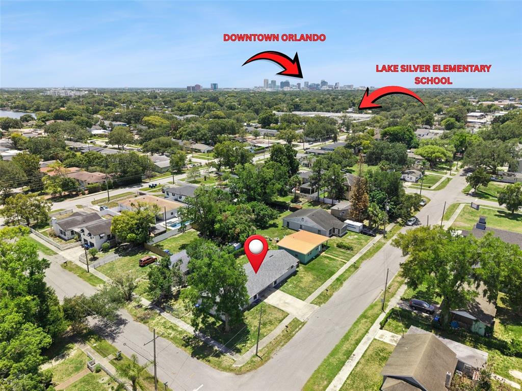 An aerial view shows a single-story house with a red location pin in a residential neighborhood — 2763 & 2765 COOLIDGE AVENUE, ORLANDO, FL
