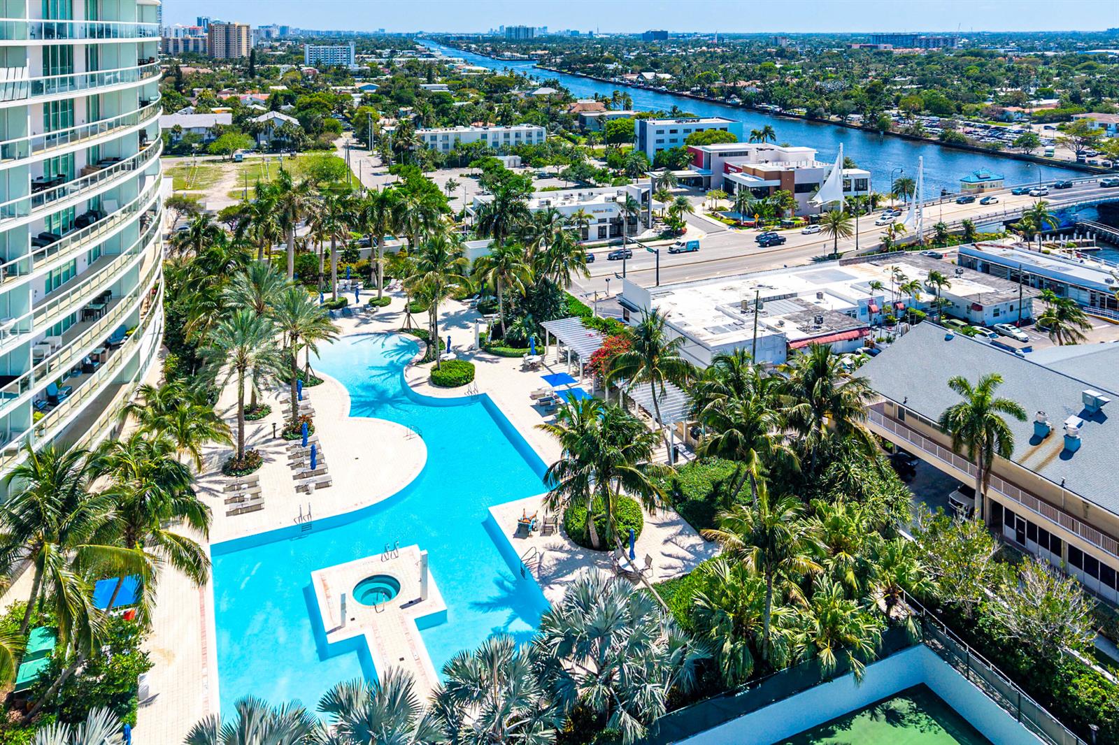 An aerial view shows a large swimming pool with a hot tub next to a building — 1 N Ocean Boulevard # 513, Pompano Beach FL 33062, POMPANO BEACH, FL