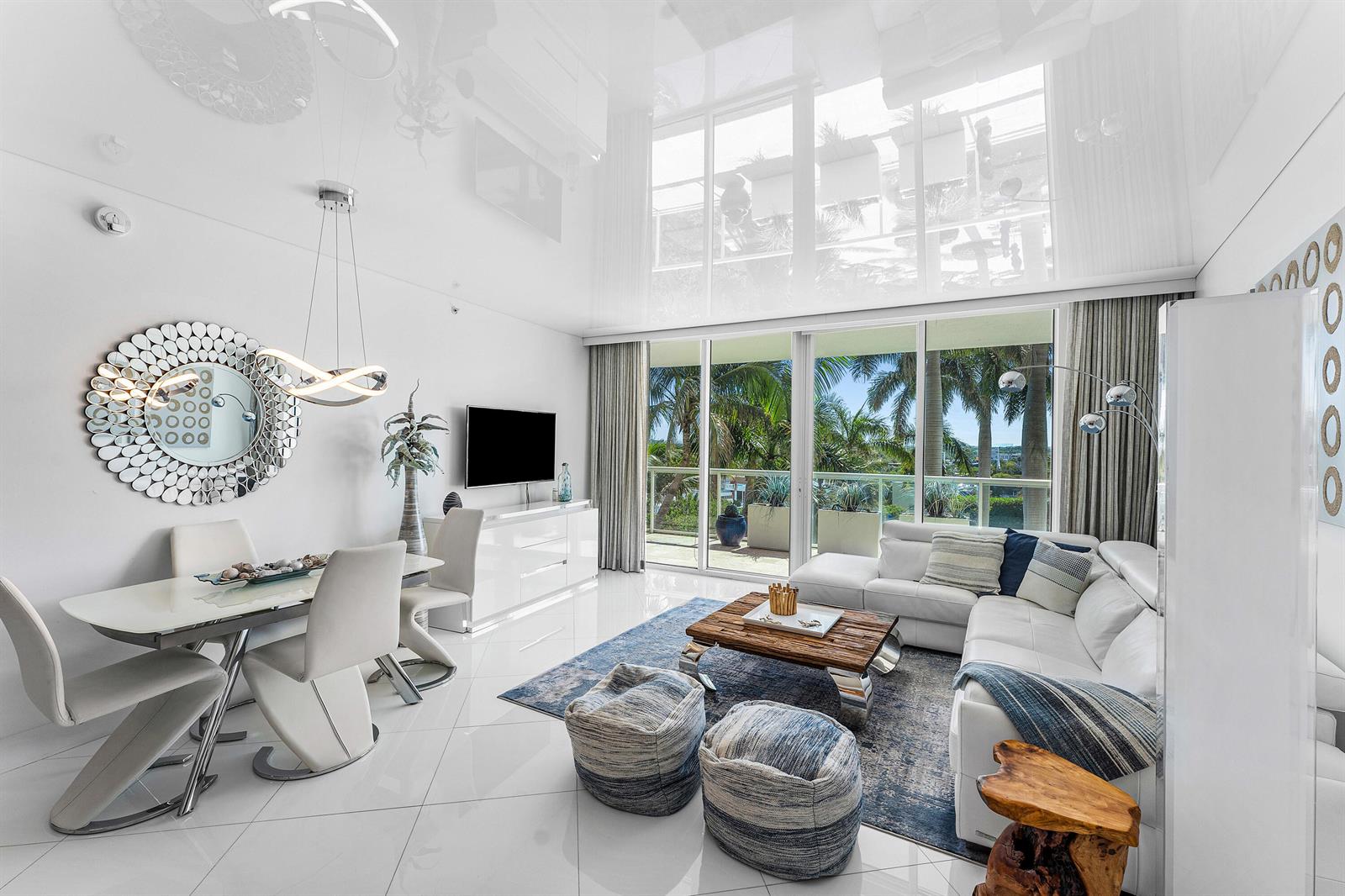 A modern living and dining area features white tile floors, high ceilings, and floor-to-ceiling windows — 1 N Ocean Boulevard # 513, Pompano Beach FL 33062, POMPANO BEACH, FL
