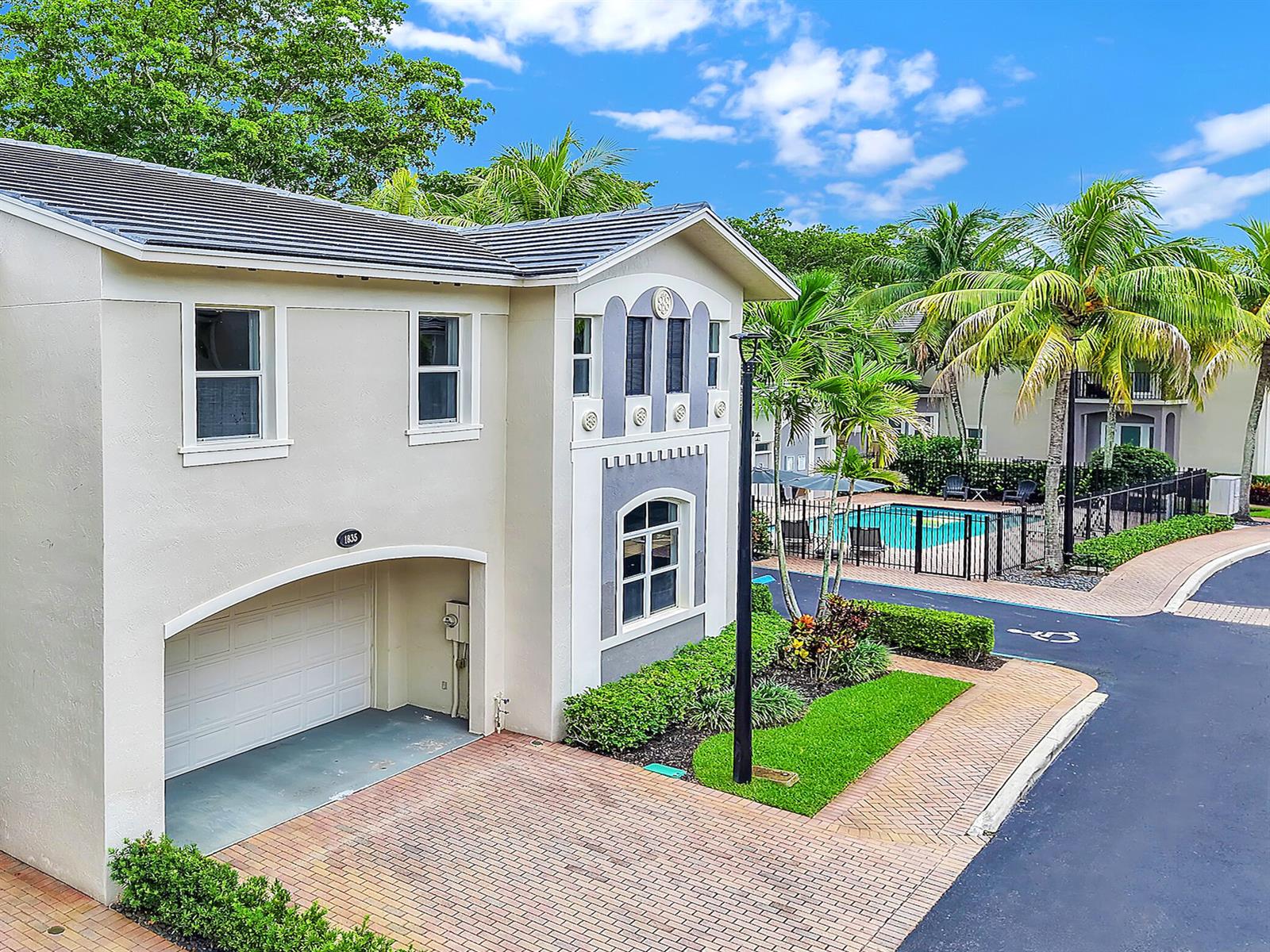 A two-story house with a garage and a nearby swimming pool behind a fence — 1835 Highland Grove Drive, Delray Beach FL 33445, DELRAY BEACH, FL