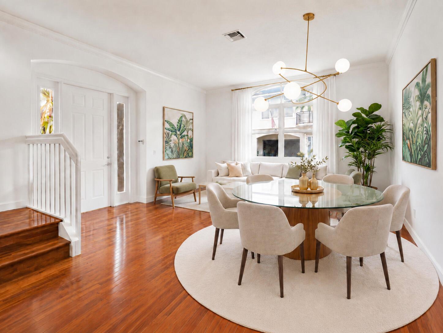 A dining area with a glass-topped table, upholstered chairs, and a modern chandelier on hardwood floors — 1835 Highland Grove Drive, Delray Beach FL 33445, DELRAY BEACH, FL