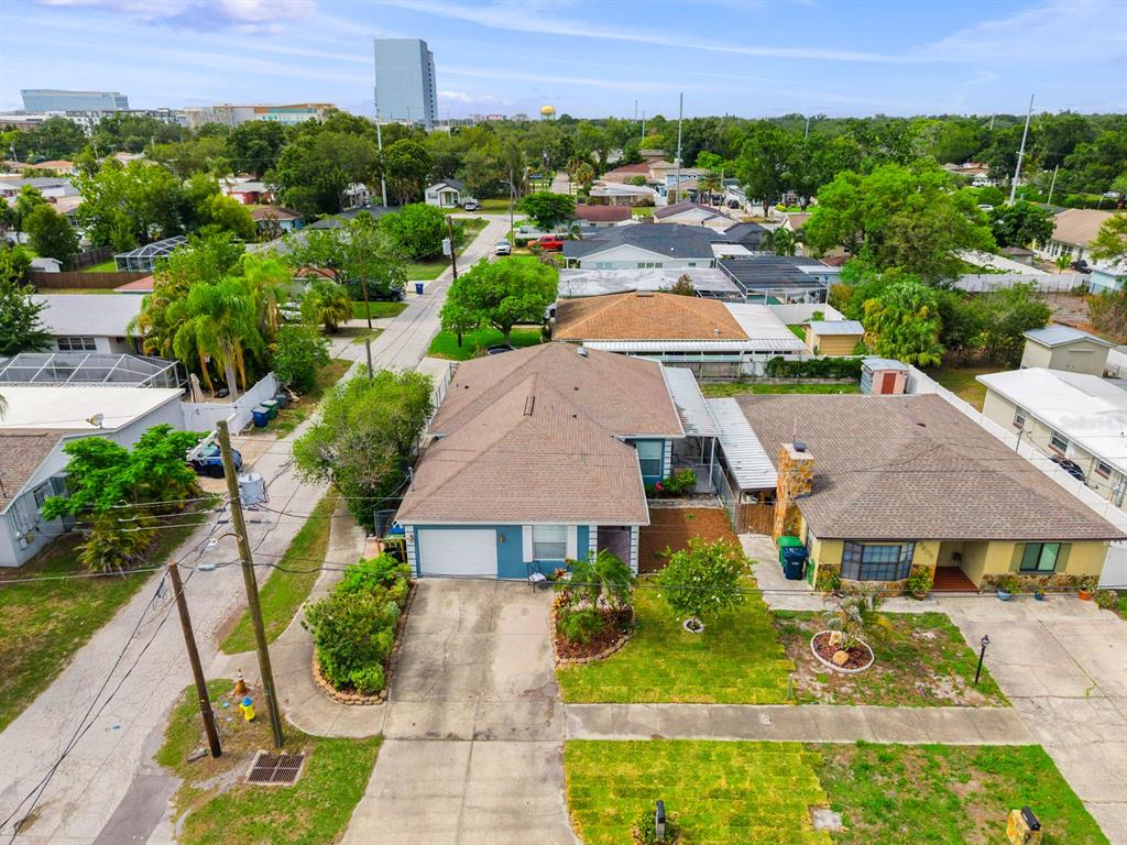 An aerial view shows a suburban house with a brown roof and a concrete driveway — 3411 W NORTH B STREET, TAMPA, FL