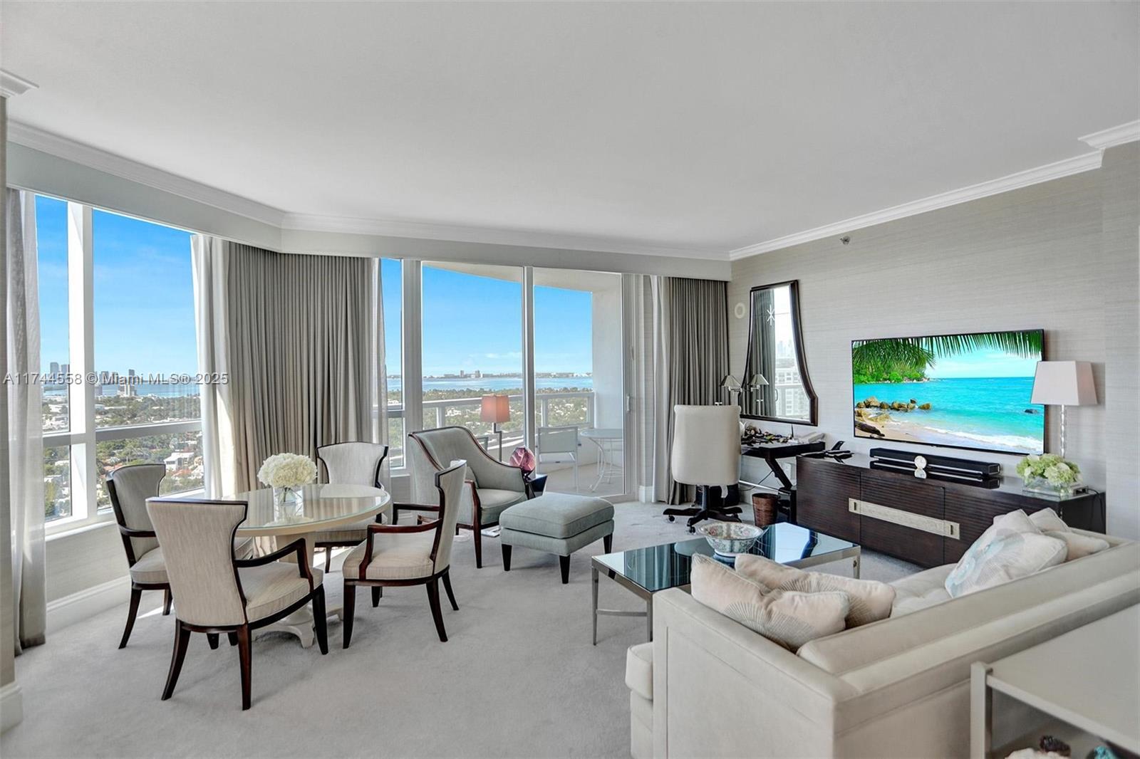 A bright living and dining area features floor-to-ceiling windows with a scenic coastal view — 4401 Collins Ave, Miami Beach FL 33140, MIAMI BEACH, FL