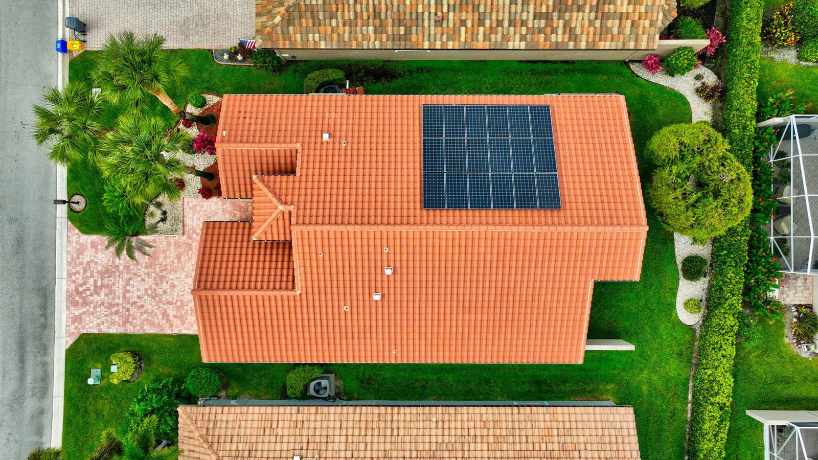 An aerial view shows a house with a red tile roof and a solar panel array — 11583 Ballylee Terrace, Boynton Beach FL 33437, BOYNTON BEACH, FL