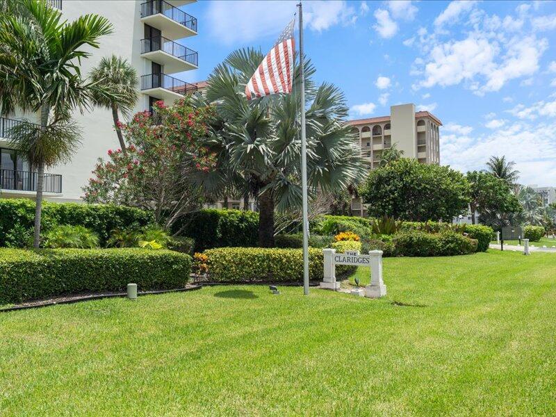 A grassy lawn features a sign for The Claridges in front of palm trees and buildings — 3456 S Ocean Boulevard # 505, Palm Beach FL 33480, PALM BEACH, FL