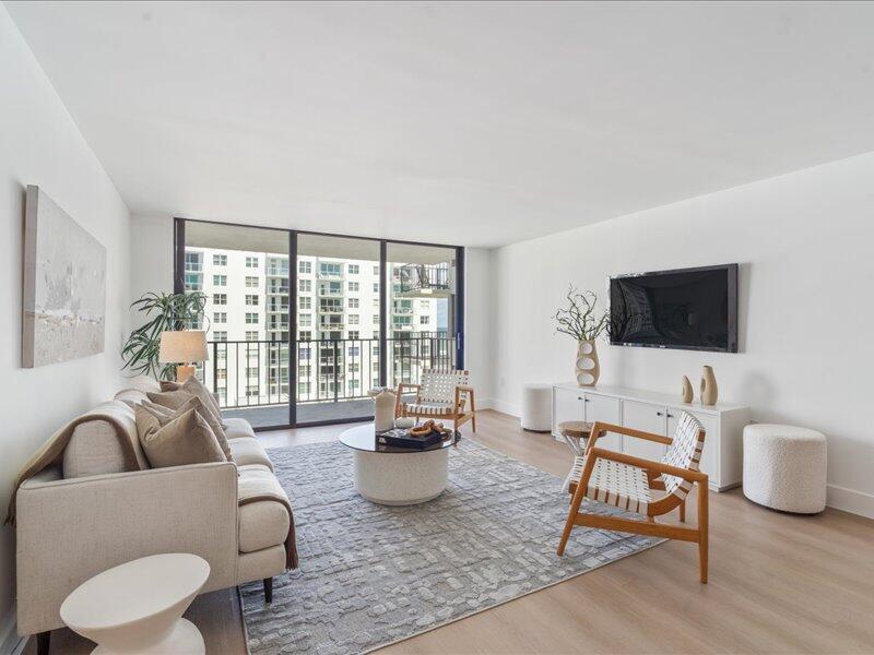 A modern living room features a beige sofa, two wooden armchairs, and a large balcony — 3456 S Ocean Boulevard # 505, Palm Beach FL 33480, PALM BEACH, FL
