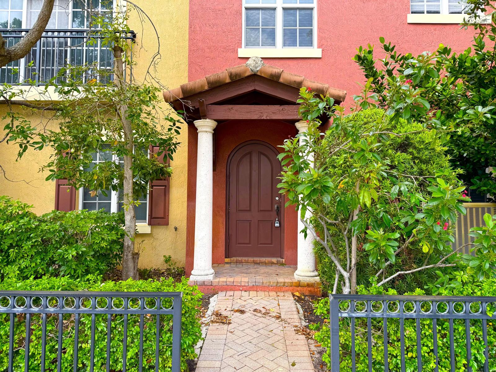 The exterior of a house features a red arched front door under a tiled portico — 531 S Federal Highway # 15, FL 33460, FL