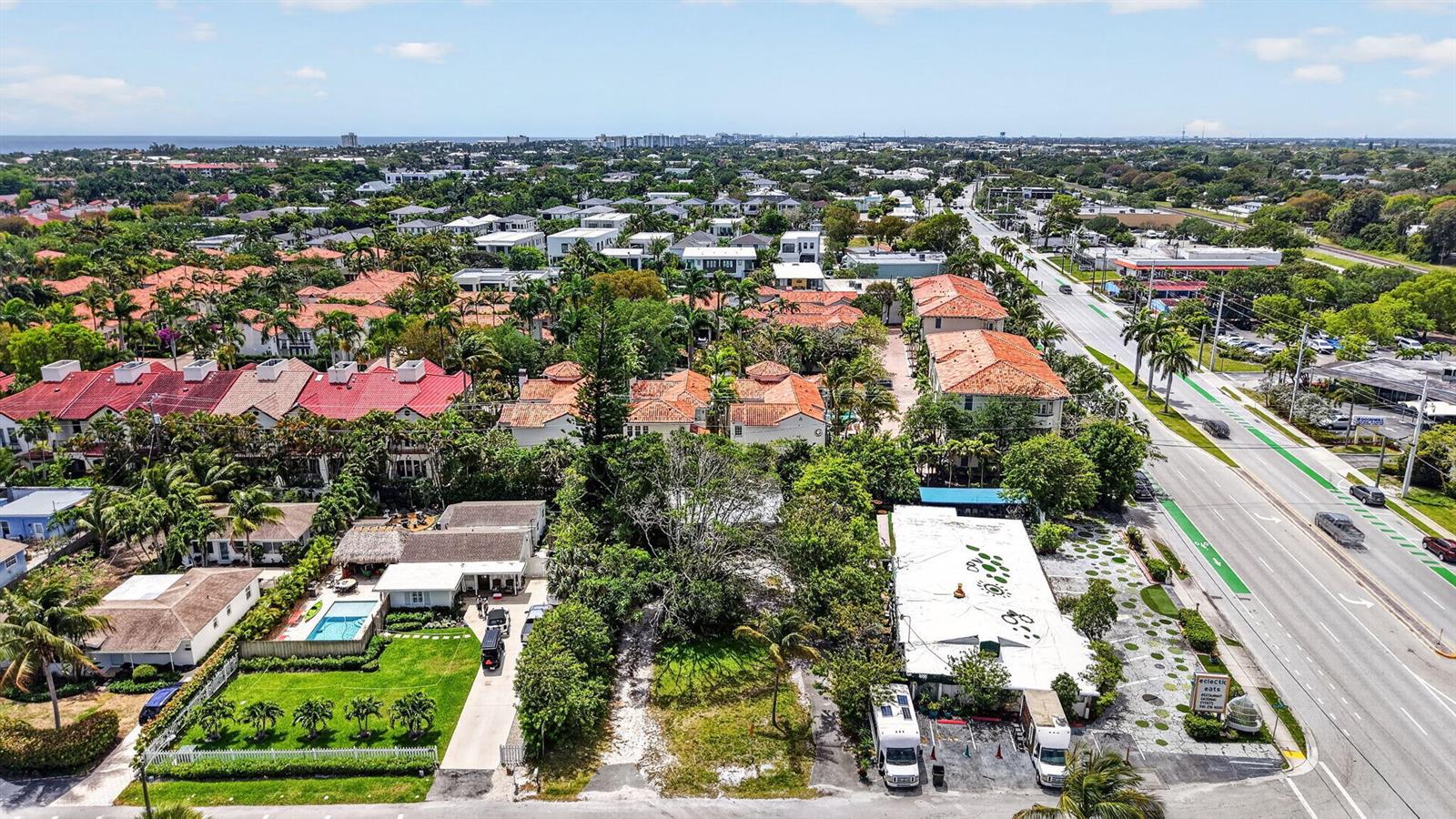 An aerial view shows a residential neighborhood with red-roofed buildings, a pool, and a road — 600 Allen Avenue, Delray Beach FL 33483, DELRAY BEACH, FL