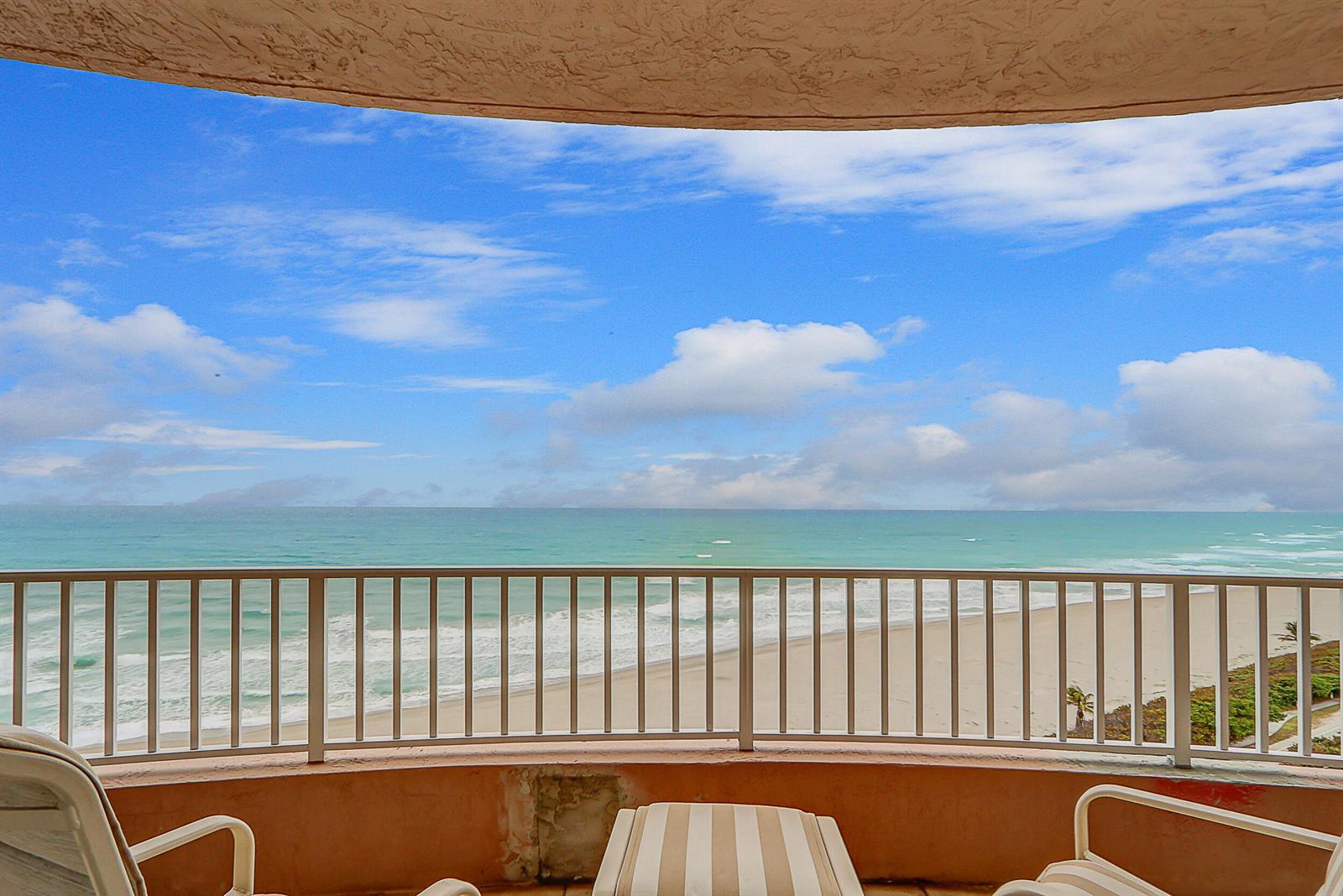 A balcony with a railing overlooks the ocean and beach under a blue sky — 750 Ocean Royale Way # 1203, Juno Beach FL 33408, JUNO BEACH, FL
