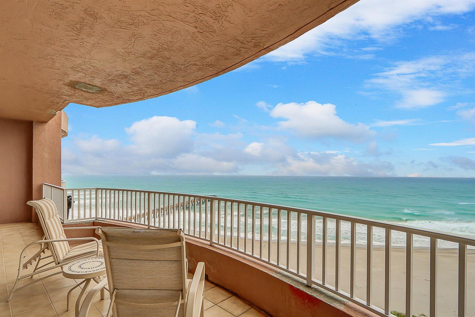 A balcony with two chairs overlooks the ocean and a sandy beach — 750 Ocean Royale Way # 1203, Juno Beach FL 33408, JUNO BEACH, FL