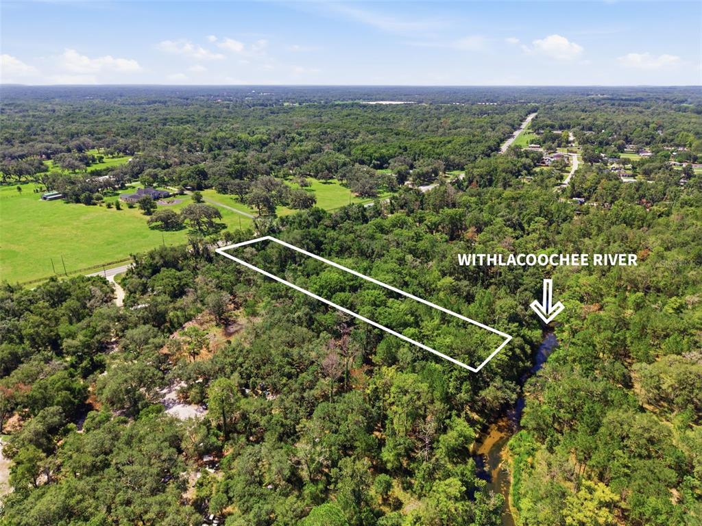 An aerial view shows a rectangular plot of land bordering the Withlacoochee River — MCKETHAN ROAD, DADE CITY, FL