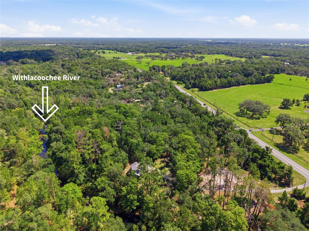 An aerial view shows a house nestled in a wooded area near the Withlacoochee River — MCKETHAN ROAD, DADE CITY, FL
