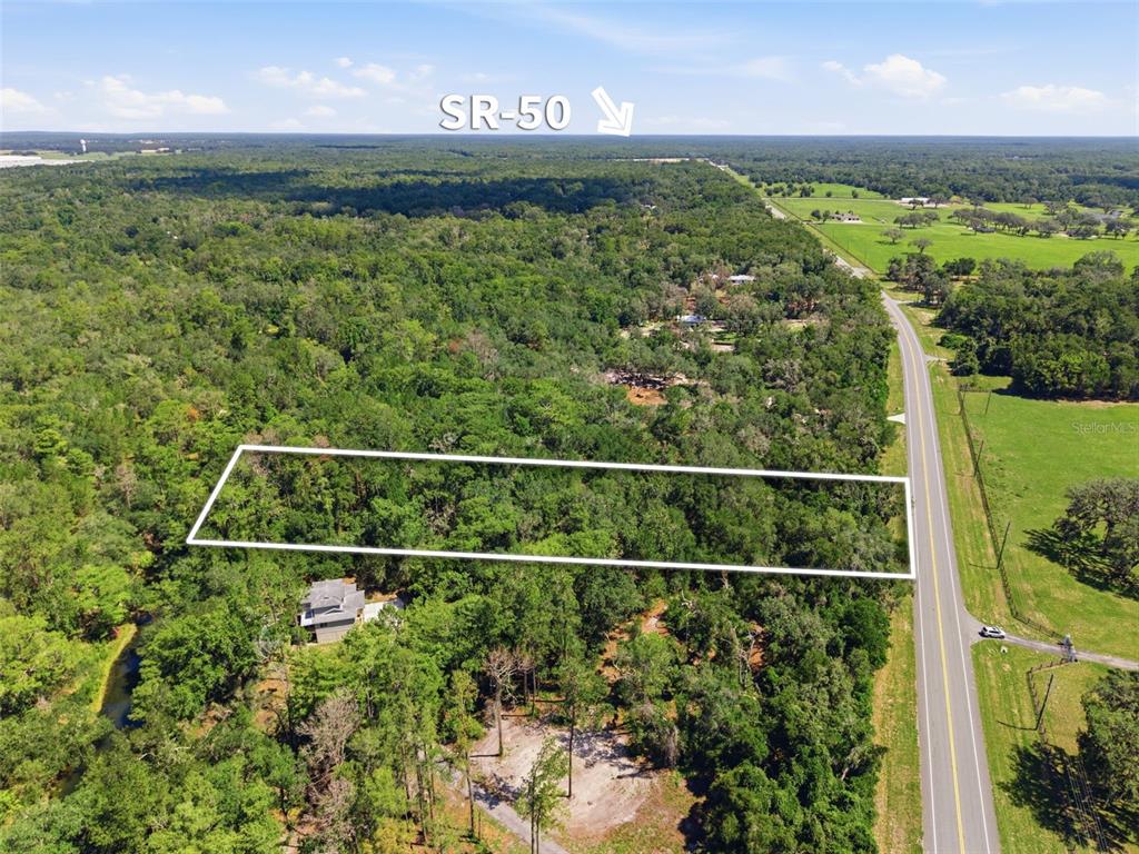 An aerial view shows a rectangular plot of land outlined in white beside a road — MCKETHAN ROAD, DADE CITY, FL