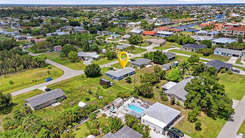 An aerial view shows a residential neighborhood with a blue house marked by a pin — 700 DOLPHIN PARKWAY, PUNTA GORDA, FL
