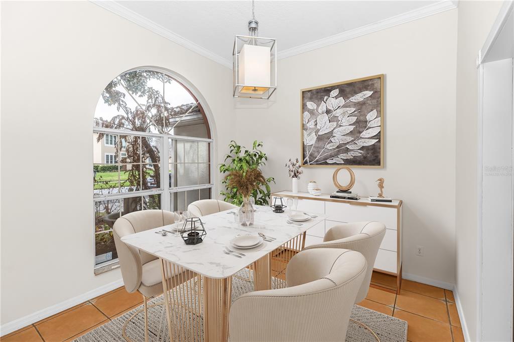 A dining room features a marble-top table, cream chairs, a pendant light, and arched window — 1587 HUNTERS STAND RUN, OVIEDO, FL