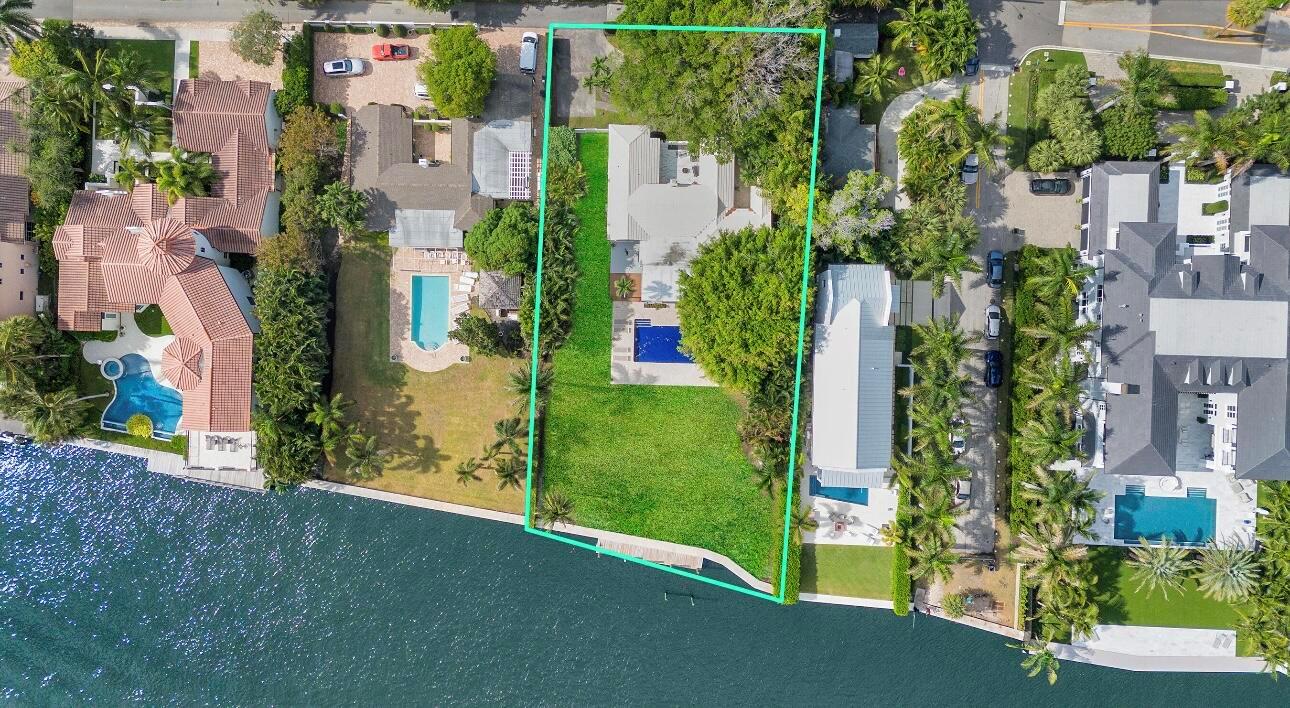 An aerial view of a waterfront residential property with a house, pool, and large lawn — 1 Fisher Lane, Delray Beach FL 33483, DELRAY BEACH, FL