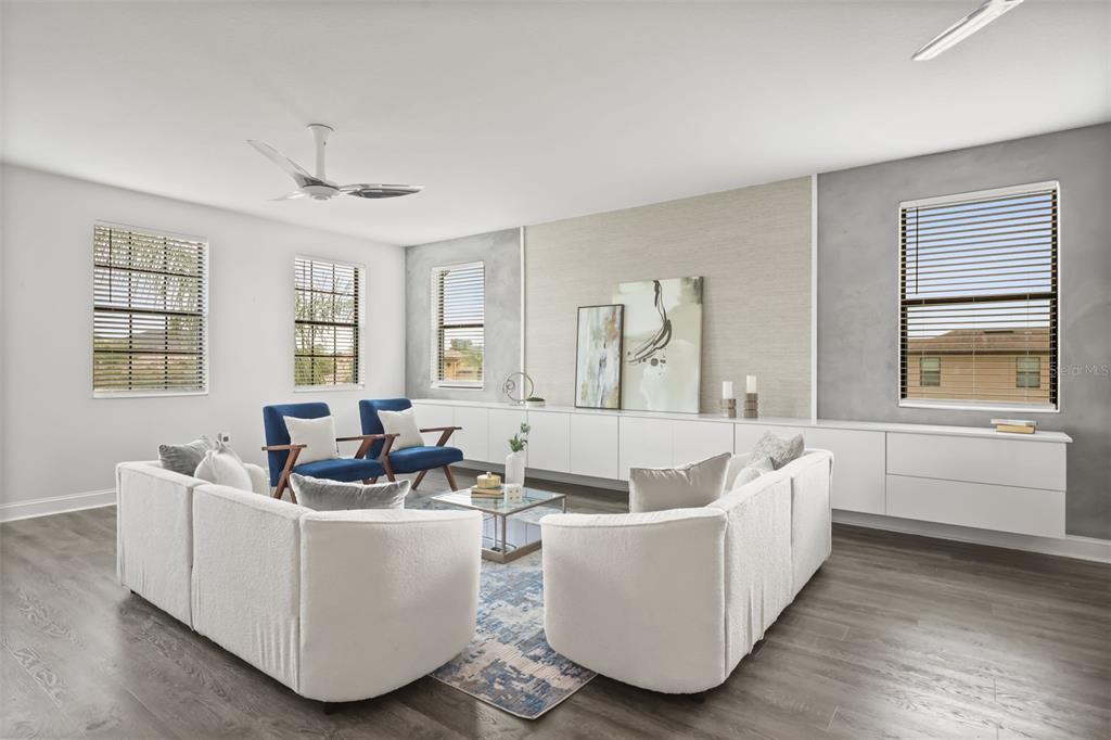 A living room features white sofas, blue accent chairs, and a long built-in wall cabinet — 17112 GUILFORD COURT, ORLANDO, FL