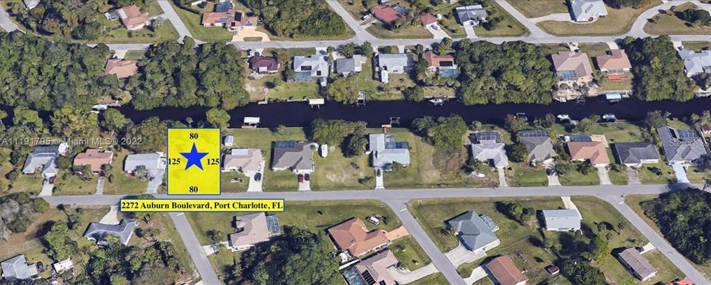 This is an aerial map showing a vacant residential lot highlighted with a blue star — 2272 AUBURN BOULEVARD, PORT CHARLOTTE, FL