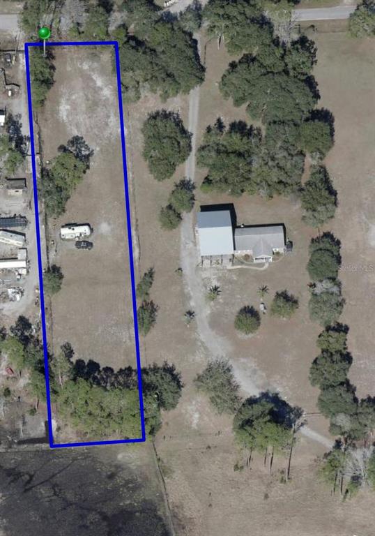 An aerial view shows a rectangular plot of land outlined in blue next to a house — 32402 PINE ROAD, EUSTIS, FL