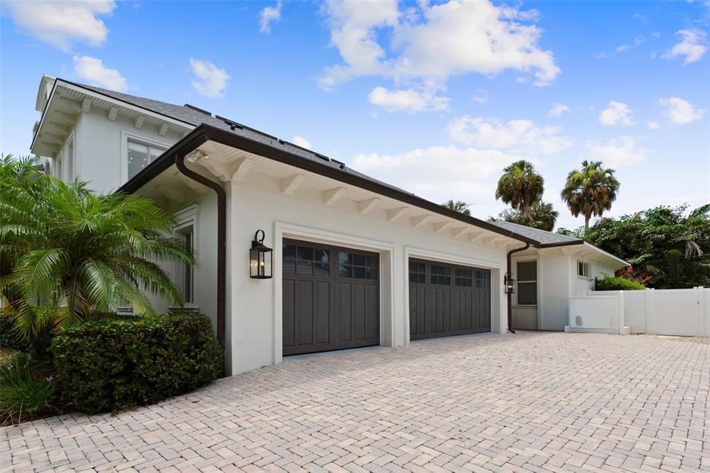 A white house with a two-car garage and a paved driveway under a blue sky — 4406 W AZEELE STREET, TAMPA, FL