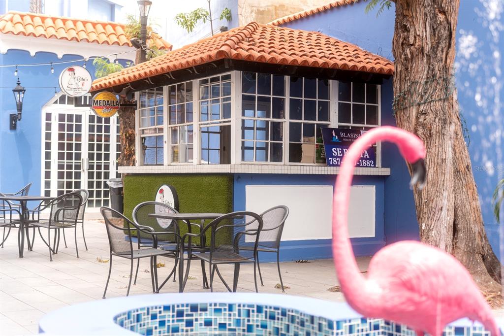 An outdoor patio area features a small kiosk with a tiled roof and metal furniture — 1 C. ISABEL MUÑOZ RIVERA, PONCE, PR