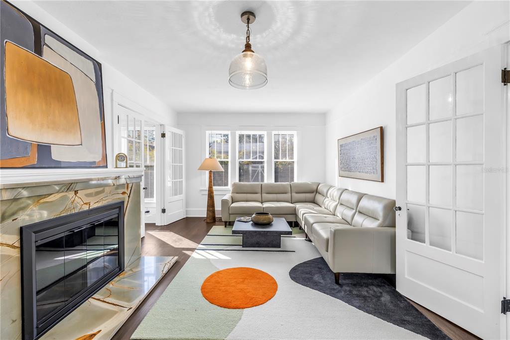 A living room features a fireplace, a sectional sofa, and a modern area rug — 2320 5TH STREET N, ST PETERSBURG, FL