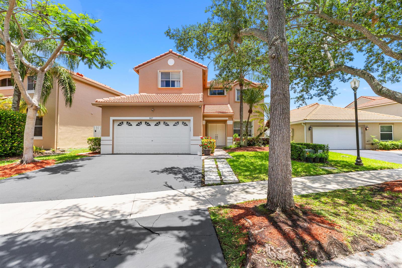 A two-story tan house with a tile roof and a two-car garage — 907 Stanton Drive, Weston FL 33326, WESTON, FL